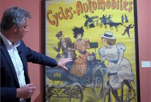The story behind the poster of the lady and the car in 1900